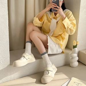 Detail of white lolita socks with cable knit texture and ruffled trim for a JK style look