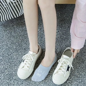 Close-up of light grey low-cut socks with white rabbit print worn with white sneakers