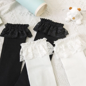 Close-up of lace trim knee-high socks in black and white styles for Lolita fashion