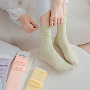 Detailed view of ruffle cuff cotton socks in macaron colors with vertical ribbed texture