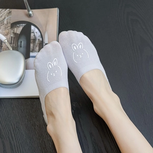 Close-up of lilac low-cut socks with cute white rabbit embroidery on breathable cotton