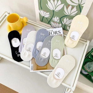Detail of colorful low-cut socks featuring cute cartoon rabbit embroidery in various shades