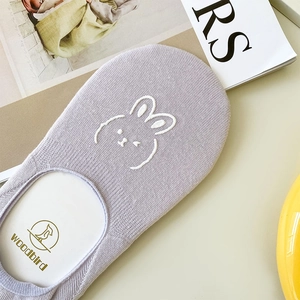 Detail shot of lilac low-cut cotton sock featuring white cartoon rabbit embroidery