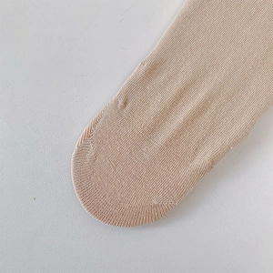 Detailed close-up of beige five-finger socks showing reinforced knit toe seams