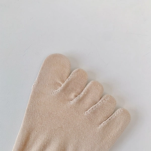 Detail of skin-tone five-toe socks featuring fine knit texture and reinforced toe seams