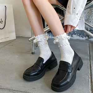 White Lolita ruffle socks with floral lace edge paired with black chunky platform loafers