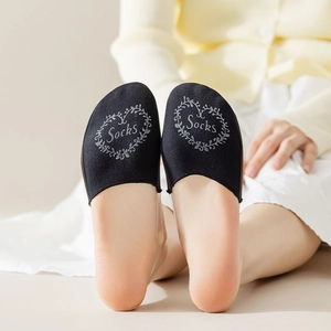 Close-up of black half-toe socks featuring a heart wreath print and soft cotton fabric