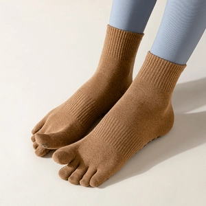 Brown five-toe yoga socks with anti-slip silicone dots and ribbed mid-calf design
