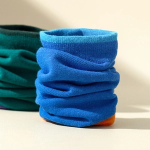 Close-up of ribbed knit neck gaiter in bright blue showing fine vertical texture