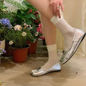 Detail of silver Tabi split-toe flats with metallic finish and lace mesh socks