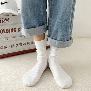 Detailed texture of white crew socks with vertical ribbed knit and elastic cuffs