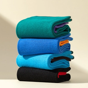 Detail of four pairs of ribbed two-toe socks showing vibrant color-block knit textures