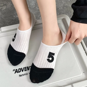 Detailed view showing high elasticity of camellia embroidered invisible boat socks