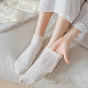 Detailed macro view of white diamond knit cotton socks with breathable mesh texture
