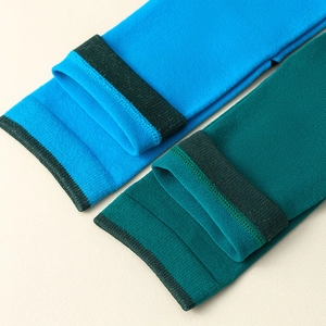 Close-up of vibrant blue and green split-toe tabi socks showing fine ribbed knit texture
