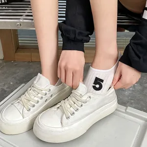 White platform canvas sneakers with floral embroidered socks and number 5 print