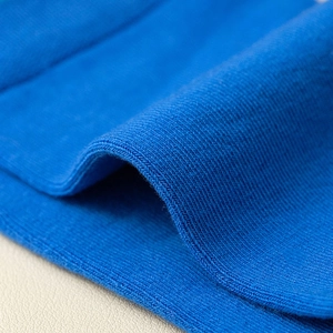 Macro shot of cobalt blue knit texture with fine ribbed structure on two-toe socks