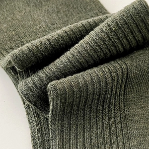 Detailed macro view of olive green ribbed knit texture on comfortable cotton socks