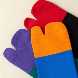 Detailed knit texture of colorful two-toe tabi socks in vibrant color-block combinations