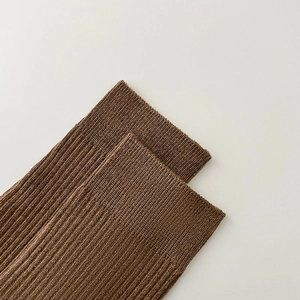 Close-up of brown ribbed knit socks featuring elastic cuffs and soft fabric texture