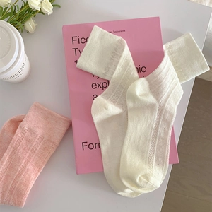 Detail of knit Lolita socks in soft pink and cream white with hollow mesh stripe texture