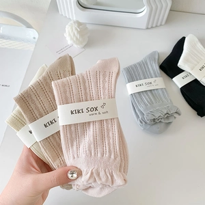 Detailed view of hollow knit cotton socks with lace trim in multiple pastel colors