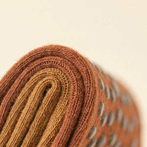 Macro detail of anti-slip silicone dots and knit texture on yoga toe socks