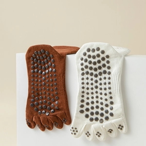 Close-up of hexagonal non-slip silicone grips on five-toe yoga socks for better traction