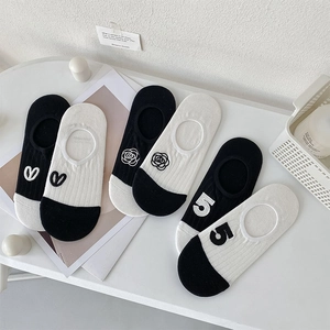 Close-up of low cut invisible socks with camellia embroidery and silicone anti-slip grip
