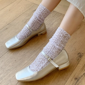 Silver square-toe Mary Jane shoes with metallic buckles and lavender lace socks