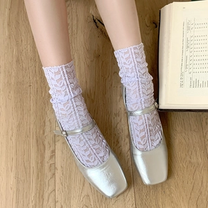 Detail of lavender floral lace socks paired with silver metallic Mary Jane flats