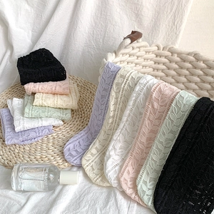 Close-up of breathable lace mesh socks with leaf patterns in various pastel colors