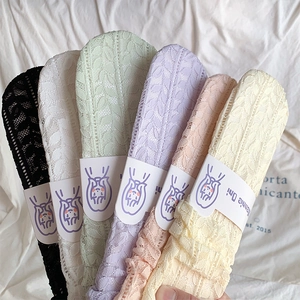 Close-up of pastel lace socks featuring intricate leaf patterns in multiple colors