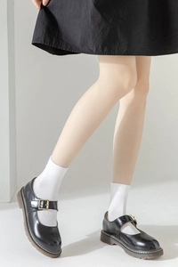 Detail of black platform Mary Jane shoes paired with white mid-calf socks for a JK style look