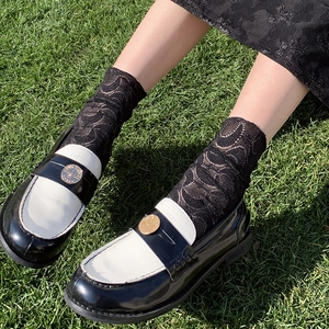 Lace lolita mid-calf socks with crescent moon patterns worn with bicolor loafers
