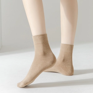 Close-up of light khaki mid-calf cotton socks with fine knit texture and ribbed cuffs