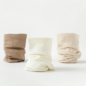 Close-up of ribbed knit neck warmers in earthy tones like camel, white, and beige