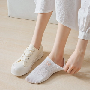 Detail showing elastic white mesh boat socks with pink bow embroidery and non-slip heel