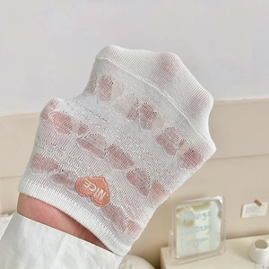 Detail of white mesh boat sock with pink heart embroidery and Nice lettering