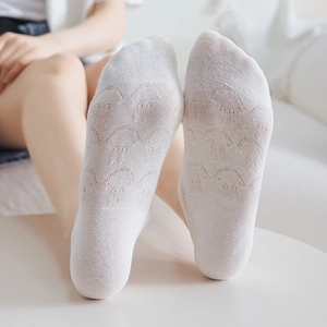 Close-up of white mesh boat socks featuring a cute knitted rabbit pattern on the sole