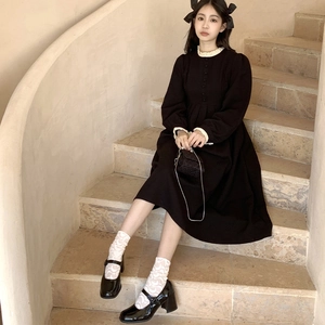 Close-up of elegant black lolita dress with white lace trim on collar and cuffs