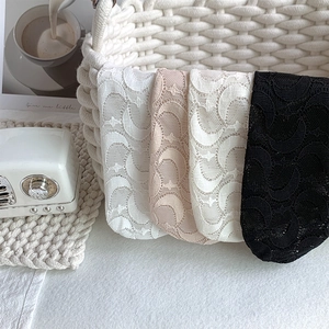 Detail of sheer lace socks with embroidered moon patterns in four elegant summer colors