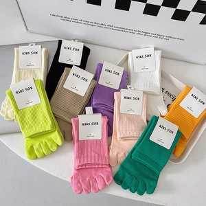 Close-up of colorful cotton five-finger socks with ribbed cuffs and individual toe design