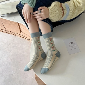Detail of vintage floral knit crew socks featuring blue contrast heel and toe accents
