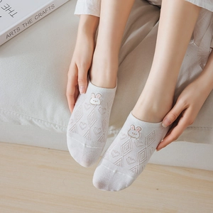 Close-up of white summer liner socks with cute bunny embroidery and mesh texture details