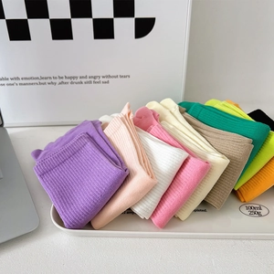 Detailed view of colorful ribbed knit crew socks neatly folded in a tray