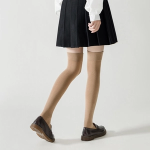 Close-up of khaki over-the-knee socks with ribbed elastic cuffs and fine knit texture