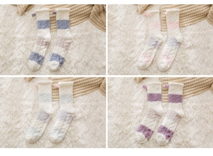 Detail of four pairs of striped coral fleece thermal socks with cute bow decorations