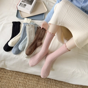 Cozy wool crew socks with ruffled edges and vertical ribbed texture in assorted colors