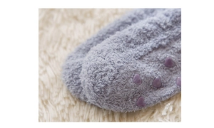 Detail of purple coral fleece sleep sock with heart-shaped anti-slip silicone grippers